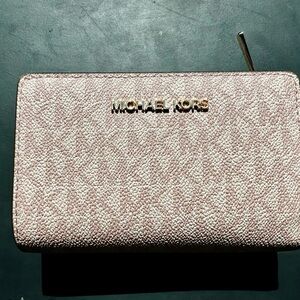Michael Kors light pink zip-around wallet with gold logo